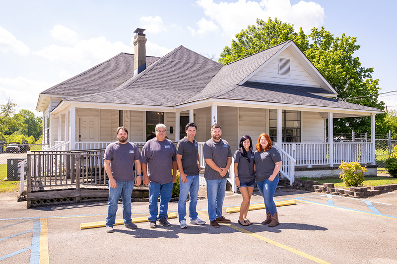 a group of people standing in front of a building
